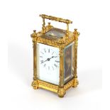 A French gilded brass carriage timepiece, having filigree work decoration, with reeded columns and