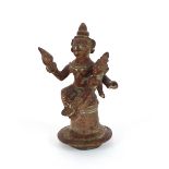 An Eastern bronze figure of a deity, holding a child, 13cm high