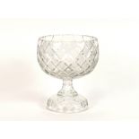 A good quality heavy cut glass fruit bowl, of hobnail pattern, raised on a circular spread foot,