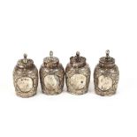 Four Eastern white metal baluster shaped pepperettes, with embossed floral decoration, 5cm high