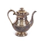 A George IV silver coffee pot, of baluster form, the hinged lid surmounted by a flower finial