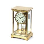 An Edwardian brass four glass mantel clock, having faux mercury pendulum by The New Haven Clock