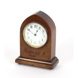 An Edwardian mahogany mantel timepiece, of Lancet shape, raised on brass ball feet, 19cm high