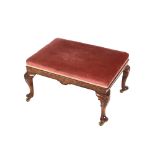 An 18th Century style walnut stool, with lifting top, raised on a shaped frieze and cabriole