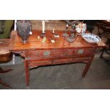 A Chinese altar table, fitted drawers and carved panels below, raised on square section supports,