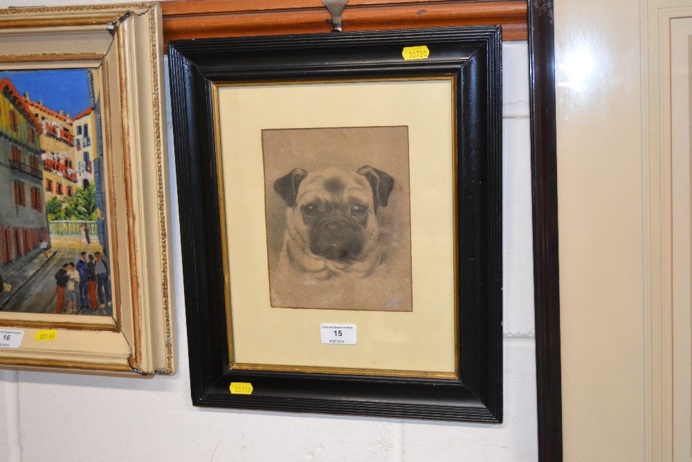 A framed and glazed charcoal study of a pug dog co