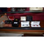 A collection of various boxed cuff links