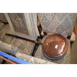 A Victorian copper warming pan