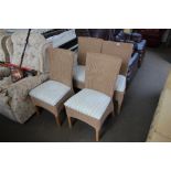 A set of four faux wicker chairs