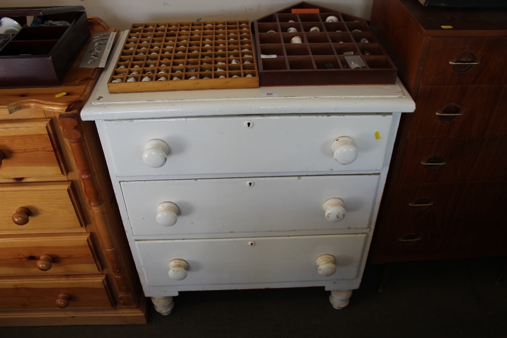 A white painted pine chest fitted three drawers