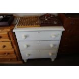 A white painted pine chest fitted three drawers