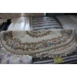 An approx. 6' x 4' oval floral patterned rug