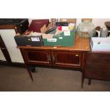 A mahogany two door cupboard with inlaid decoratio