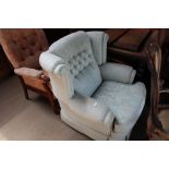 A floral upholstered blue wingback armchair