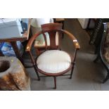 An Edwardian mahogany and inlaid tub chair