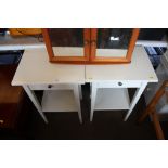 A pair of white painted bedside tables fitted sing