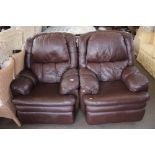 A pair of brown leather upholstered reclining arm