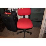 A red upholstered swivel office chair