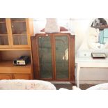 A mahogany glazed display cabinet raised on claw a