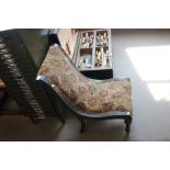 A floral upholstered nursing chair raised on turne