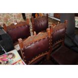 A set of four oak and leather upholstered chairs