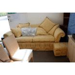 A gold floral upholstered three seater settee with