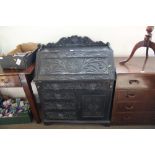 An Edwardian bureau fitted four drawers with face m