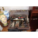 A Singer hand sewing machine with carrying case