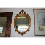 A gilt framed oval wall mirror