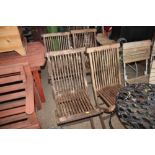 A set of four hardwood folding garden chairs