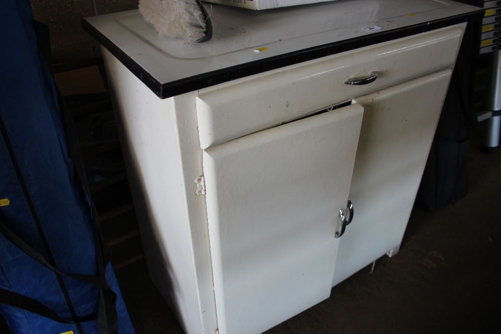 An enamel top kitchen cabinet