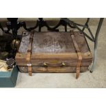 A large pig skinned suitcase