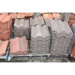 A pallet of grey and red roof tiles