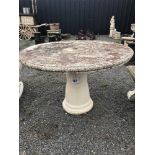 A pre-cast circular garden table, standing 70cm wi