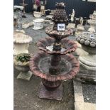 A pre-cast bronze effect garden water feature with