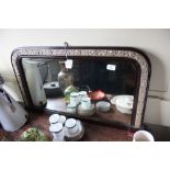 A faux walnut and gilt overmantel mirror