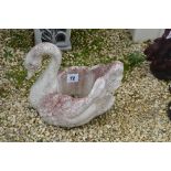 A pre-cast planter in the form of a swan,