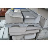 A quantity of large shaped concrete window sils