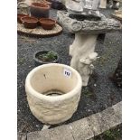 A bird bath in the form of a tree trunk, pre-cast,