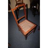 An Edwardian cane seated bedroom chair