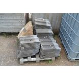 A pallet of concrete peg tiles etc.