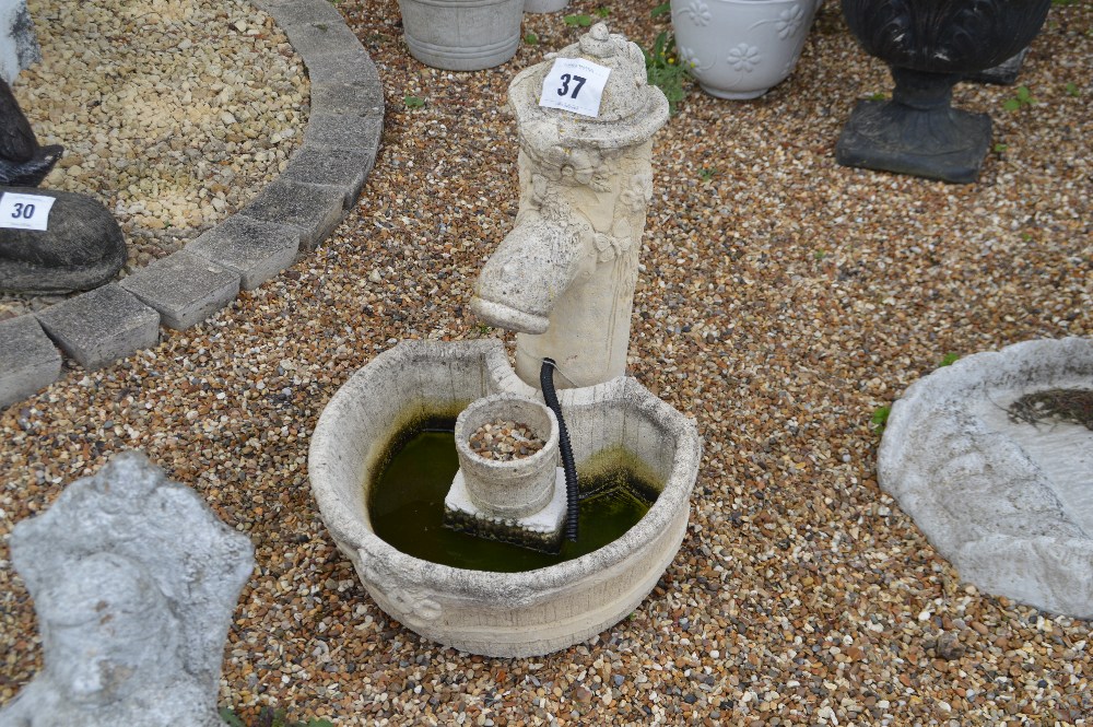 A pre-cast garden water feature comprising pump an