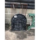 An original cast iron fire back, approx. 69cm and two grills