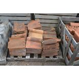 A pallet of terracotta roofing tiles