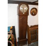 An oak long case clock with three train movement