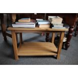 A light oak two tier occasional table
