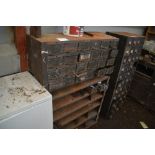 A set of metal pigeon-holes with metal shelves bel