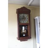 A 1920's oak cased wall clock