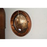 A circular gilt convex wall mirror