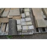 Four pallets of slabs and paving blocks and wooden posts
